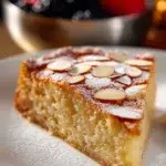Delicious homemade almond cake garnished with almonds and powdered sugar