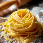 Gordon Ramsay preparing homemade pasta with fresh ingredients and tools.
