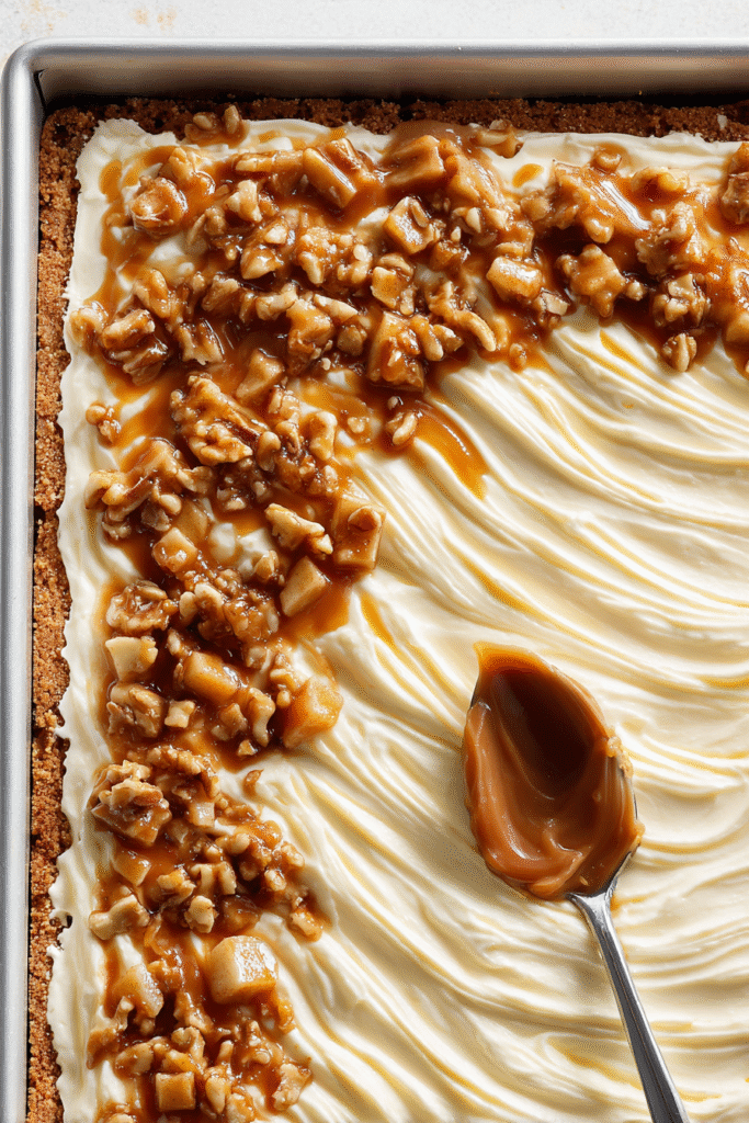 layering caramel apple cheesecake bars before baking