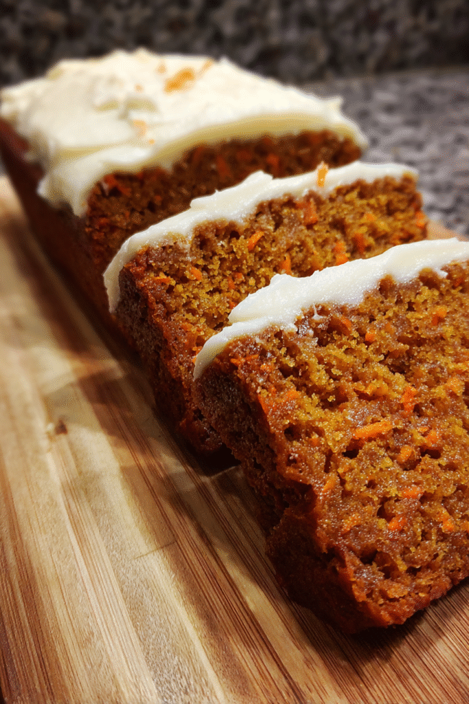 sliced carrot spice loaf with cream cheese frosting and walnuts