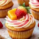 Delicious Mango Strawberry Cupcakes topped with vibrant frosting