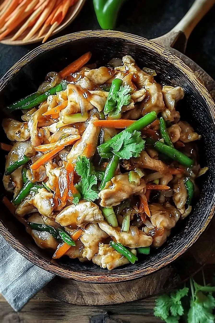 Delicious Moo Shu Chicken served with pancakes and fresh vegetables.
